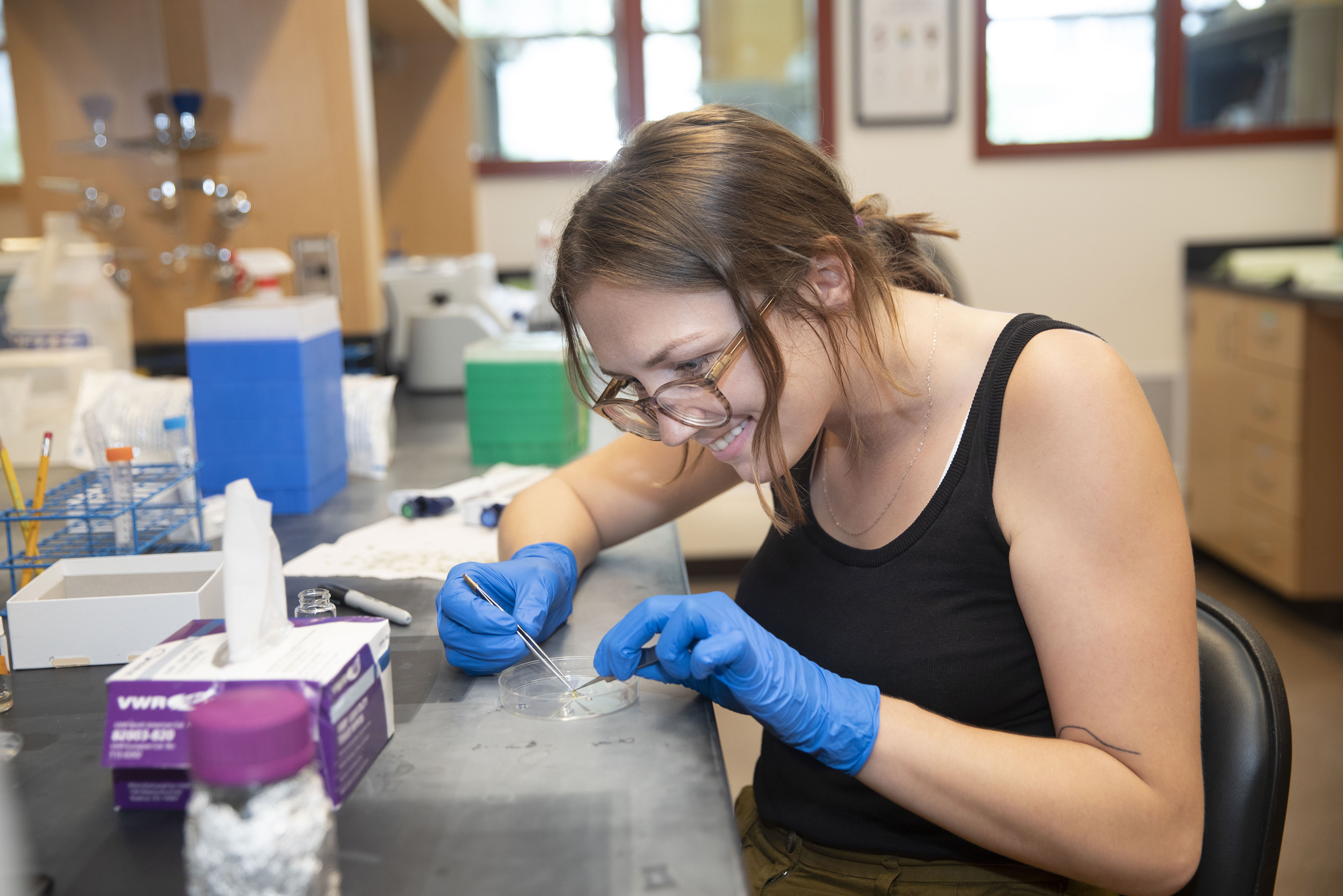 Grace Burgin works at a science lab bench.