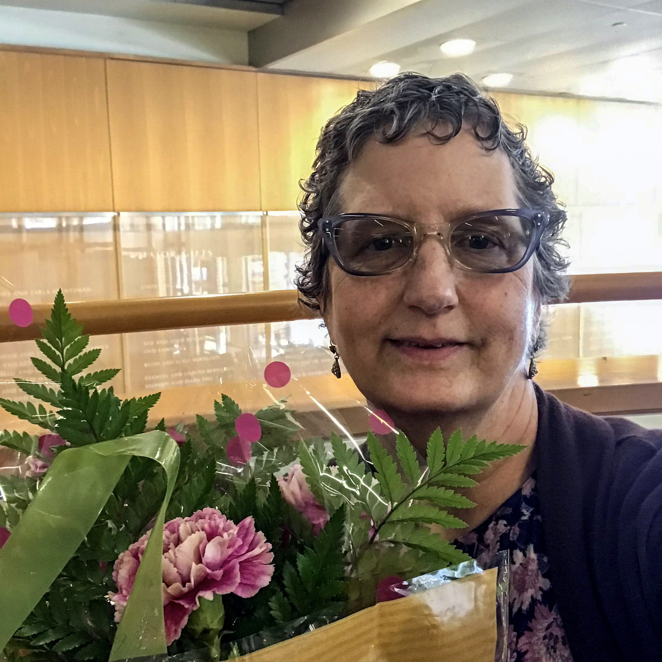 Bobbie Collins holds bouquet of carnations.