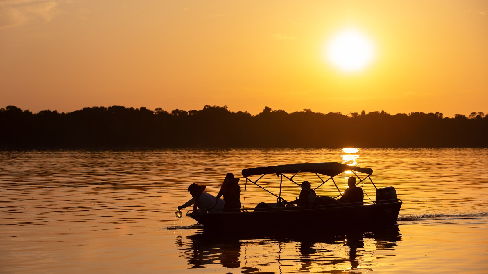 Researchers during water collection at dawn on the Rio Negro.