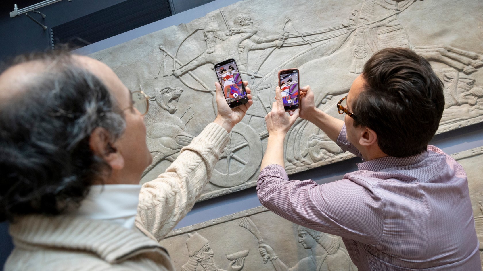 Peter der Manuelian (left) and Adam Aja demonstrate using the AR features