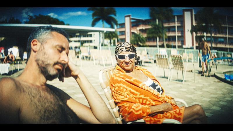 Ari Nagel and his mother sitting poolside. 