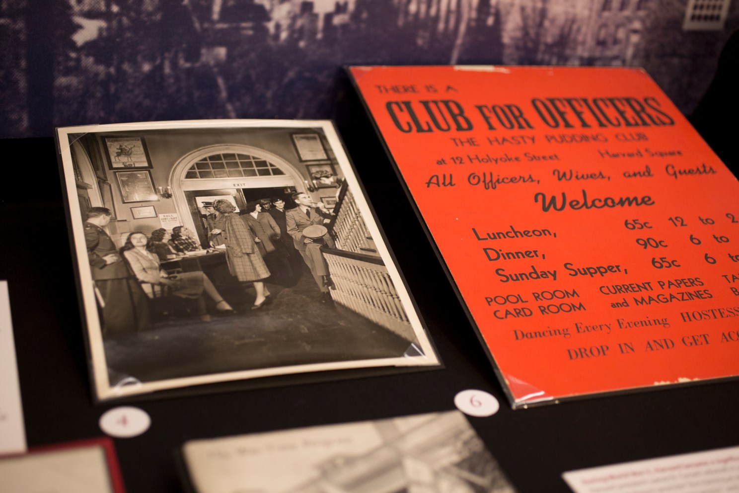 Historic photo and flyer in an exhibit about the military at Harvard