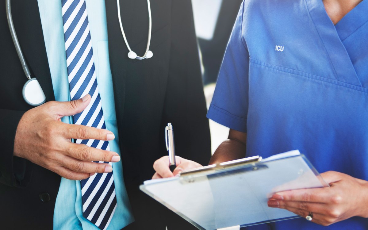 doctor and nurse looking at chart