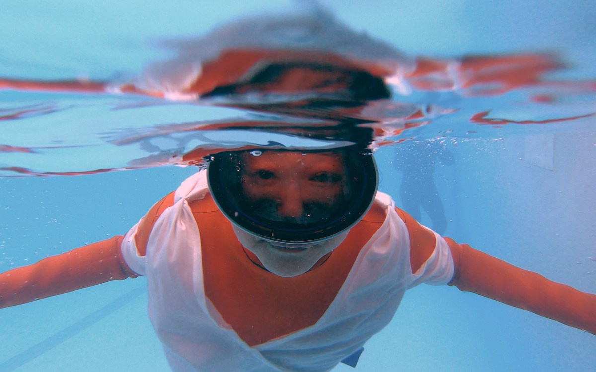 Jo Yang in rehearsal, diving underwater.