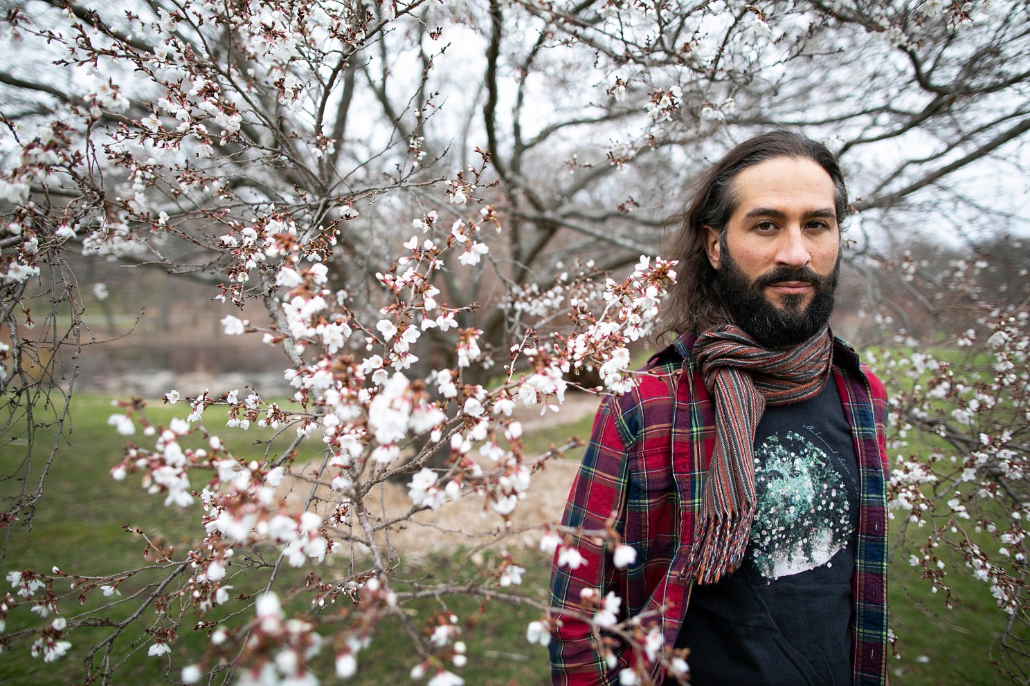 Samimi standing near a tree