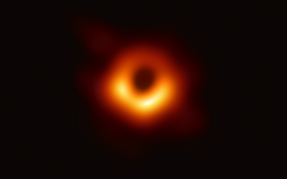 In the first picture of a black hole, it is outlined by emission from hot gas swirling around it under the influence of strong gravity near its event horizon.