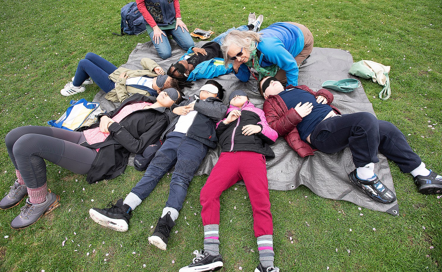 children lying on the grass