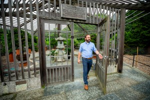 Steve Schneider walking out of bonsai greenhouse at the Arnold Arboretum