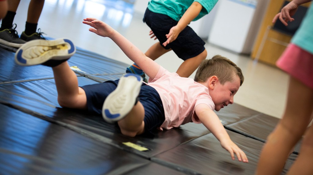 Luke Scanlon acts like an airplane during the American Repertory Theater workshop.