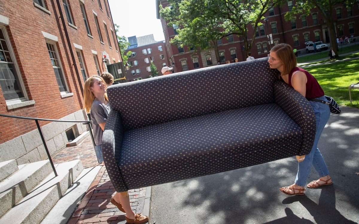 Students carrying a couch