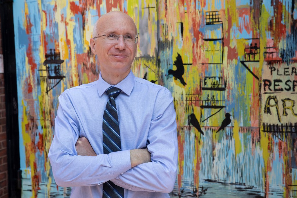 Aaron Bernstein standing in front of art