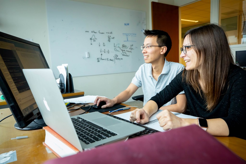 Two researchers looking at a computer.