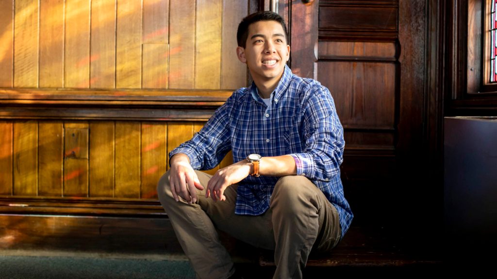 Jason sitting in a wooden room with the sun streaming in