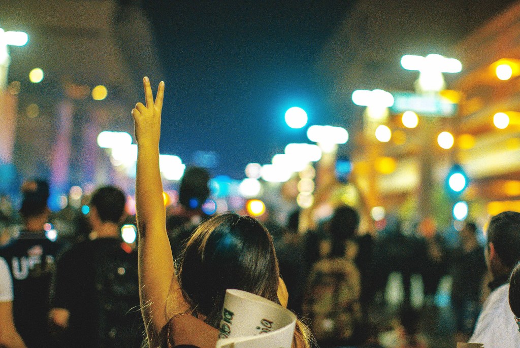 Person holding up peace sign.