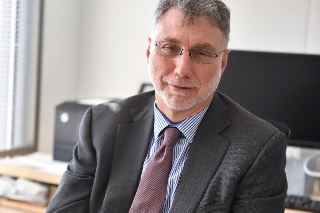 Photo of Marty Baron at his desk.