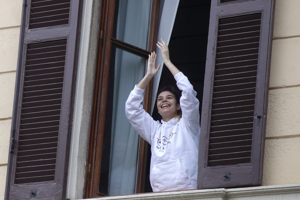 Smiling woman in a window.