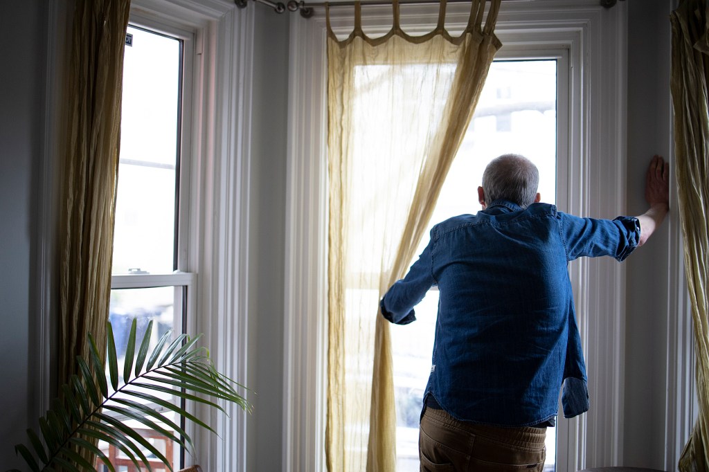 Man looking out the window.