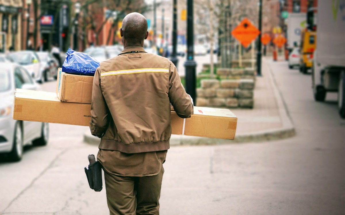 A delivery man with pacakges.