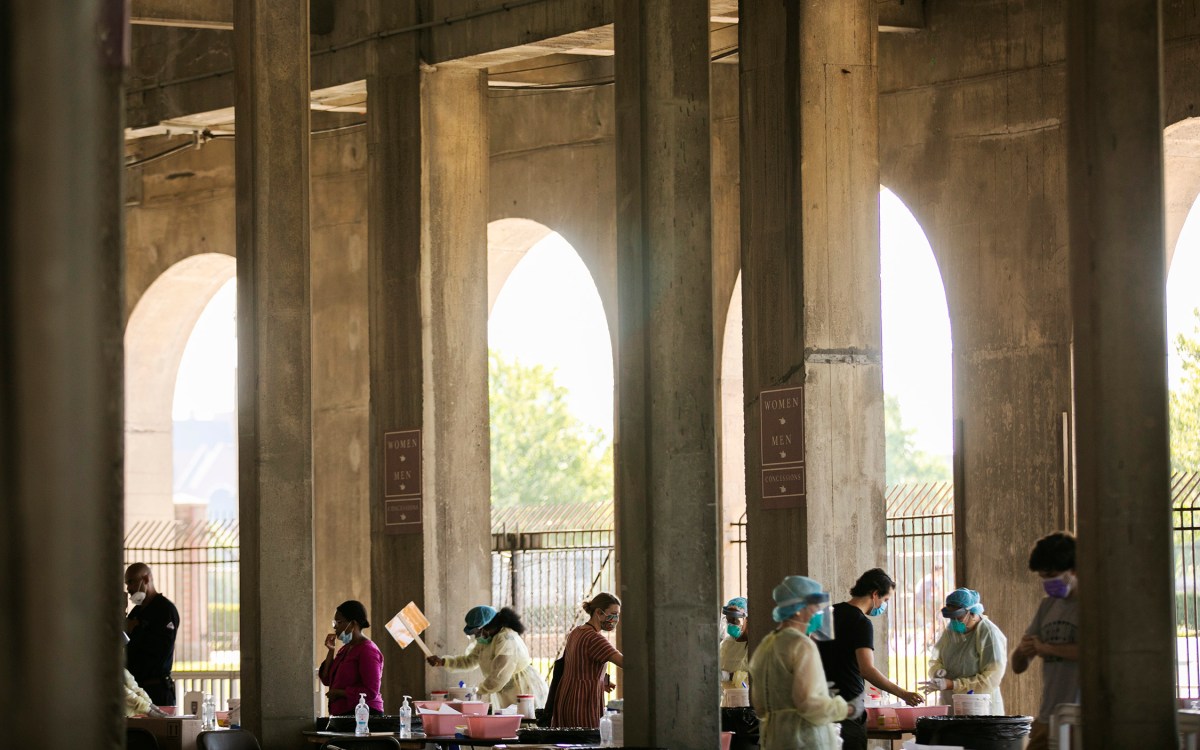 COVID-19 testing takes place in the open-air concourse of Harvard Stadium.