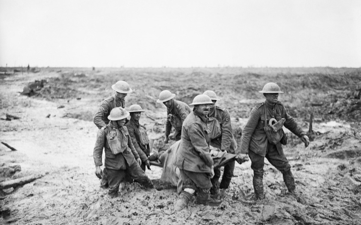 Carrying injured in hip-deep mud.