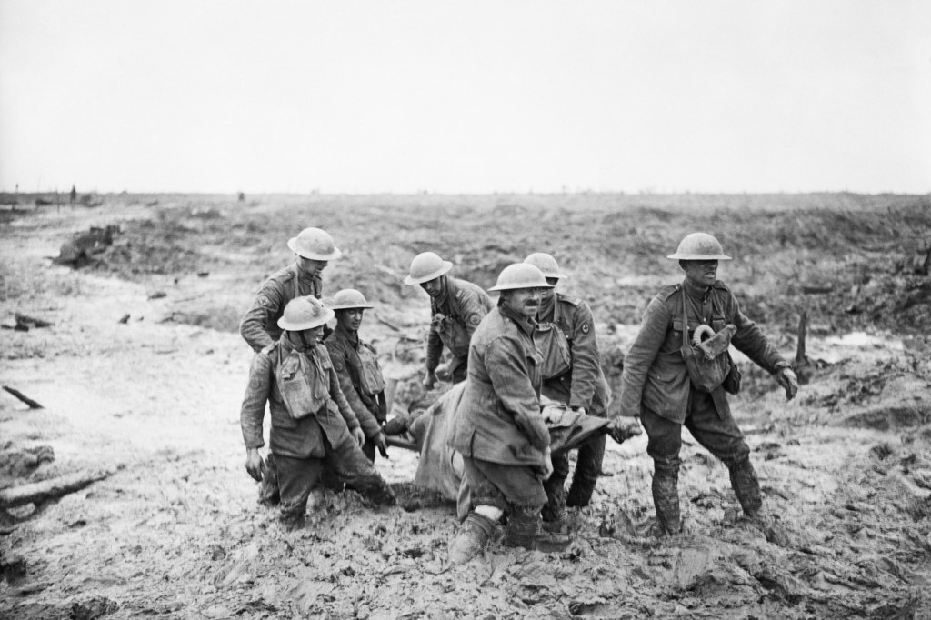 Carrying injured in hip-deep mud.