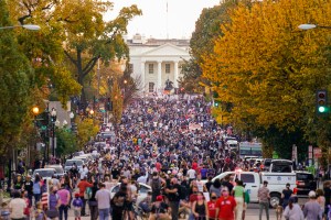 People gather along 16th street in front of the White House.