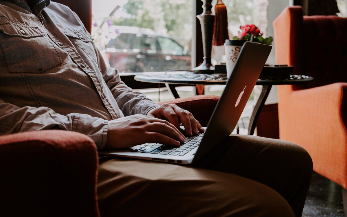 Man working on computer in casual setting.