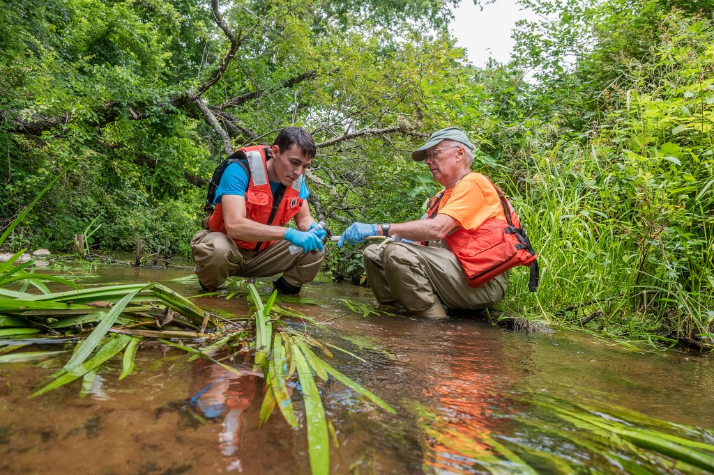 Scientists test water.