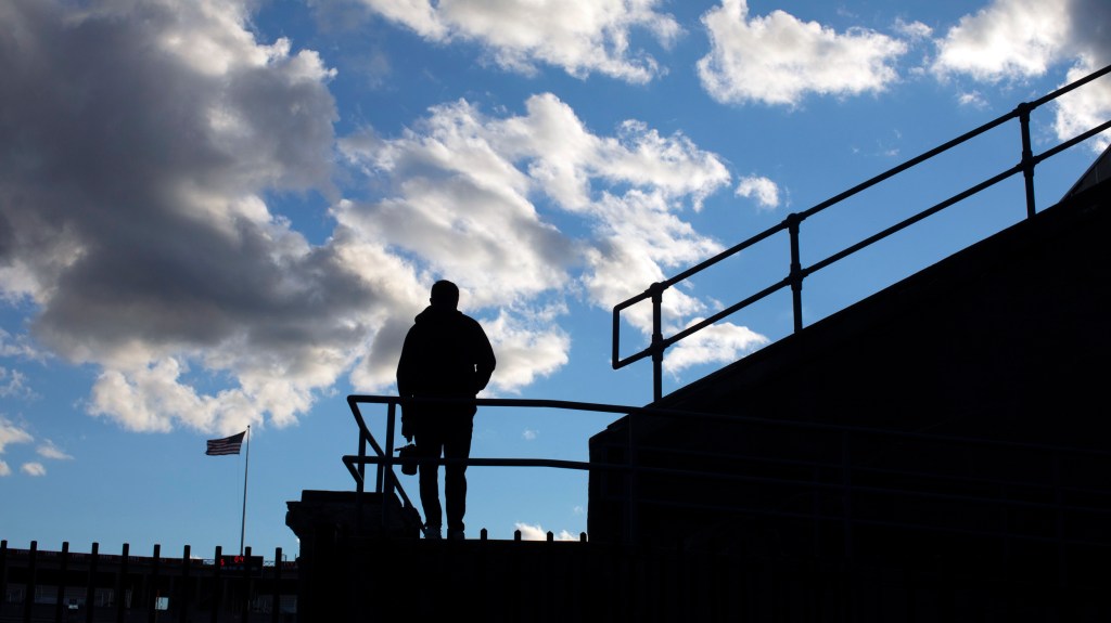 Silhouette of person at stadium.