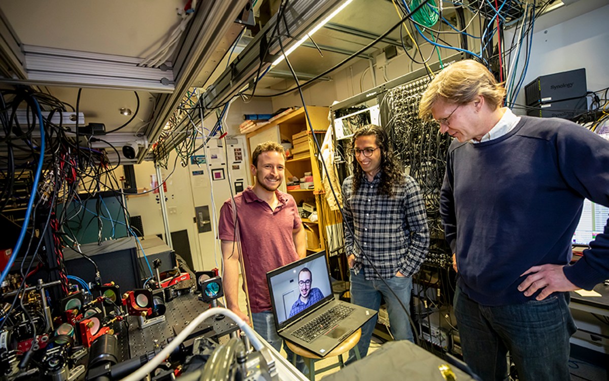 Dolev Bluvstein, Harry Levine (on the laptop), Sepehr Ebadi and Mikhail Lukin, on right, standing next to their neutral atom