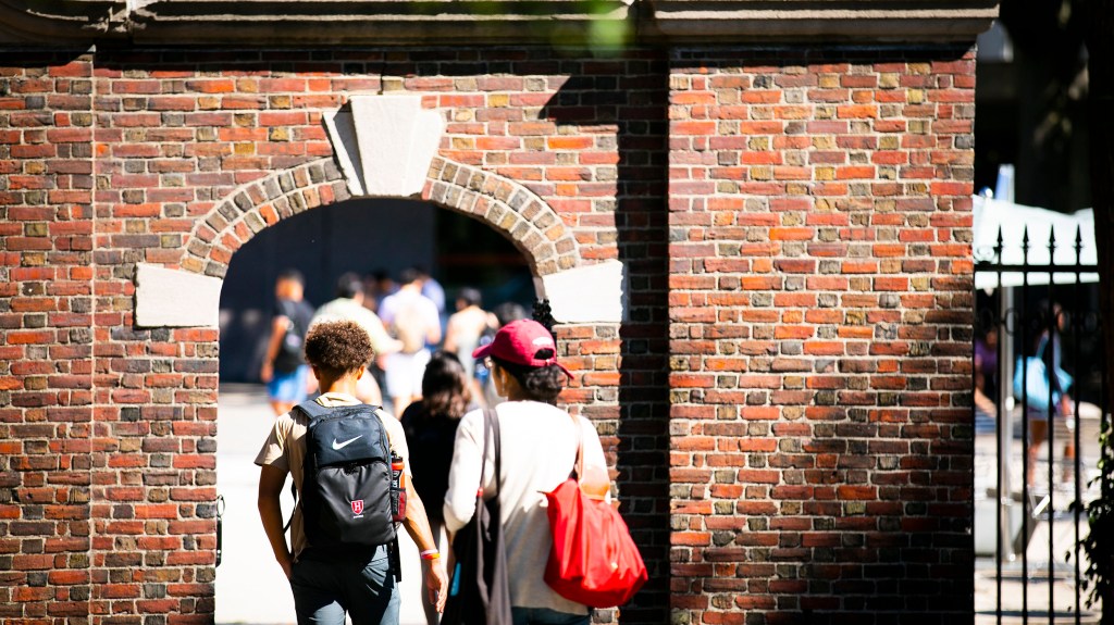 Students enter campus gate.