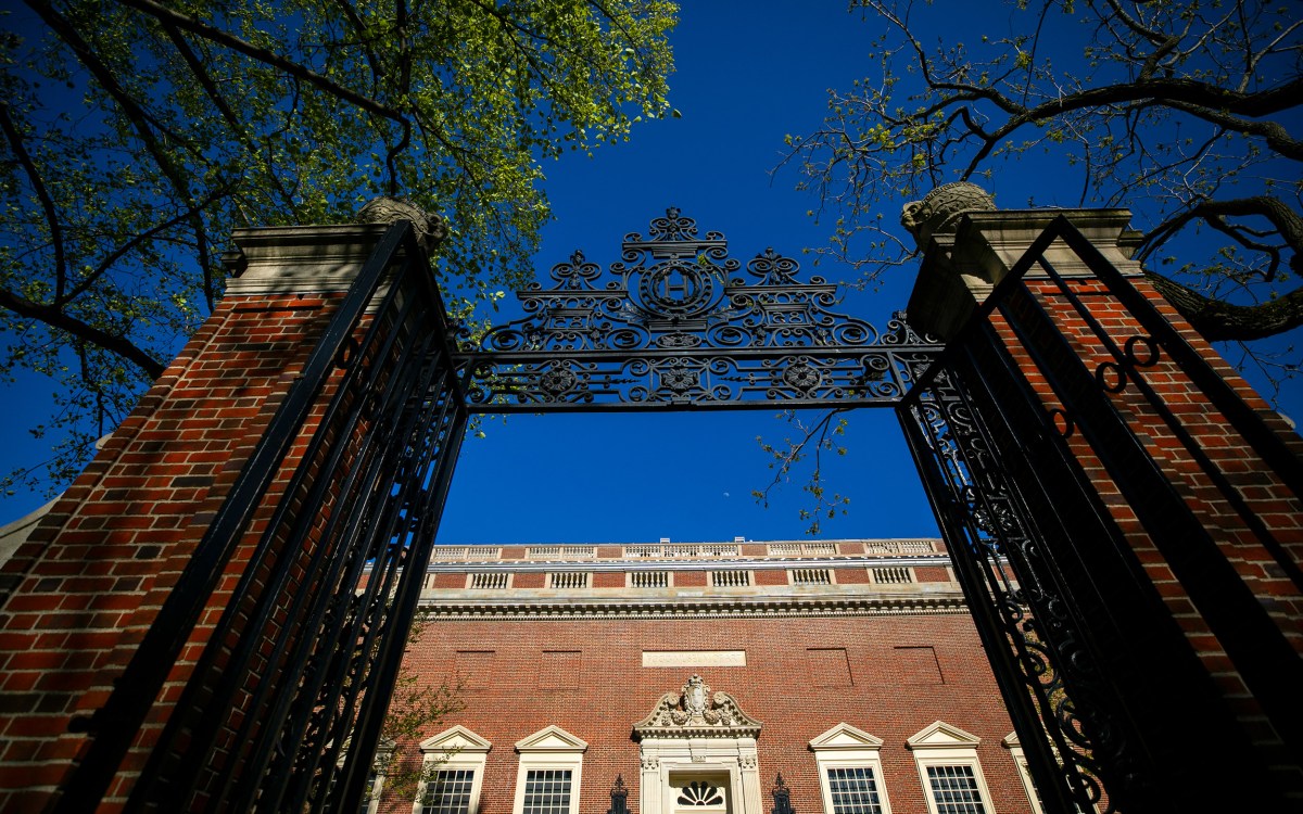 A Harvard Yard gate frames Harvard Art Museums at Harvard University. S