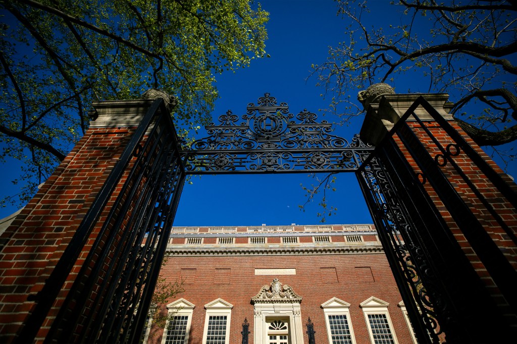 A Harvard Yard gate frames Harvard Art Museums at Harvard University. S