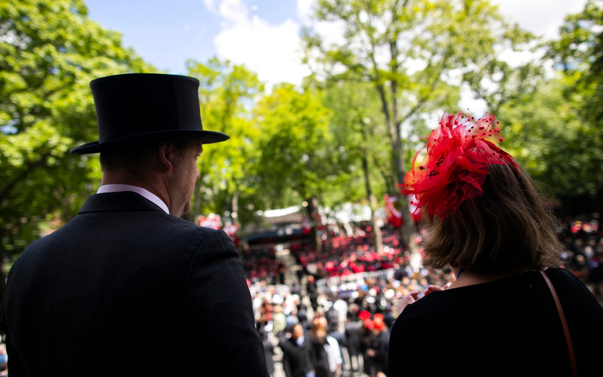 Nate Warren and Elizabeth Sapia silhouetted against Commencement backdrop in Harvard Yard.