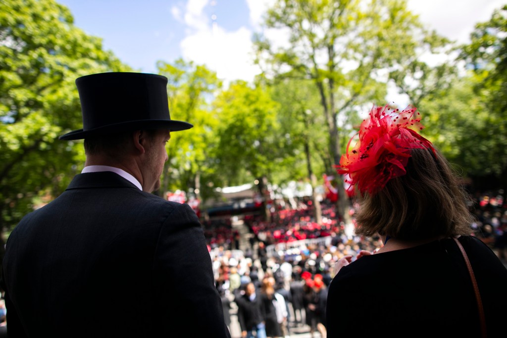 Nate Warren and Elizabeth Sapia silhouetted against Commencement backdrop in Harvard Yard.