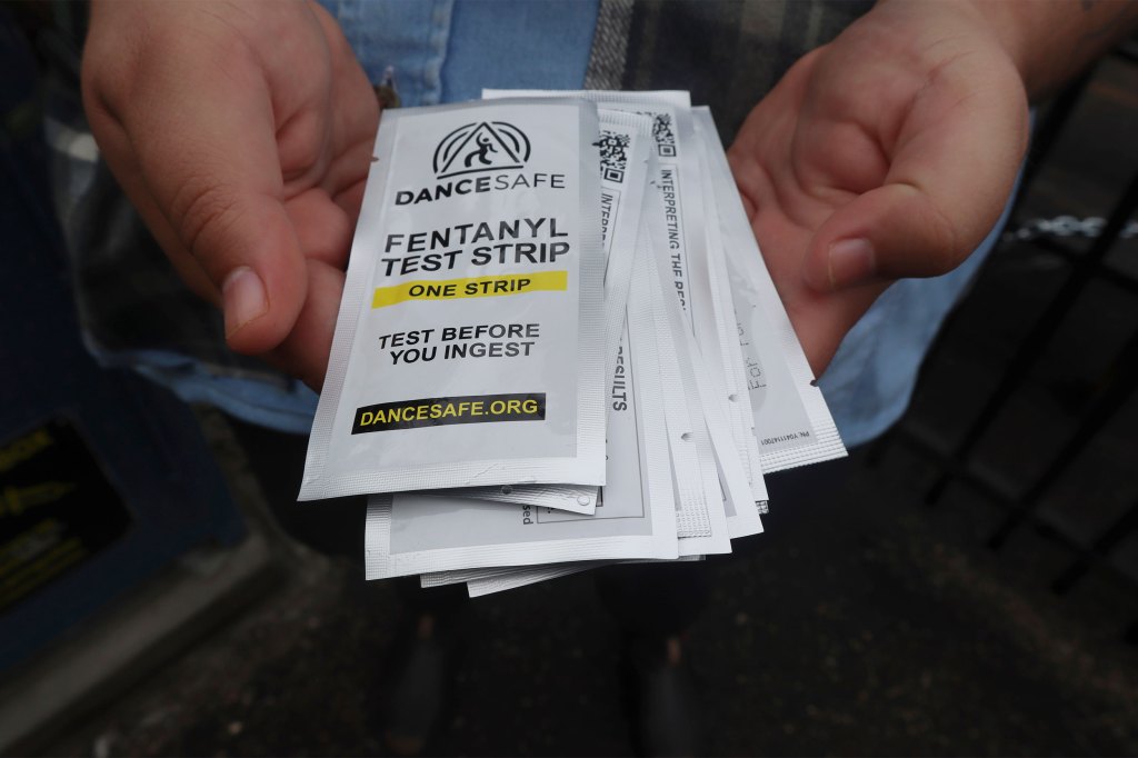 Person holds fentanyl testing strips.