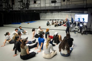 Blue Man Group member Pete Simpson demonstrates movement to students in Harvard physical theater class.