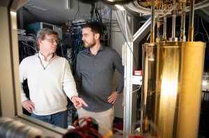 Mikhail Lukin (left) and Can Knaut stand near a quantum network node.