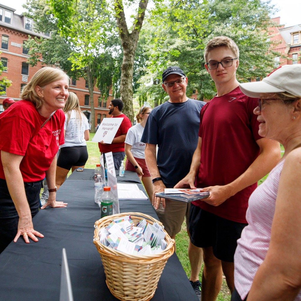 Hopi Hoekstra, Edgerley Family Dean of the Faculty of Arts and Sciences (left), speaks with Win Georg, Nathan Georg ’28, and Dolores Georg.