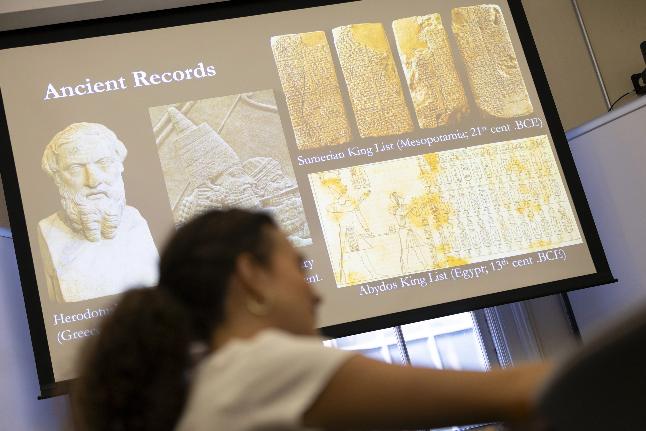 A slide displays “Ancient Records” during the class presentation.