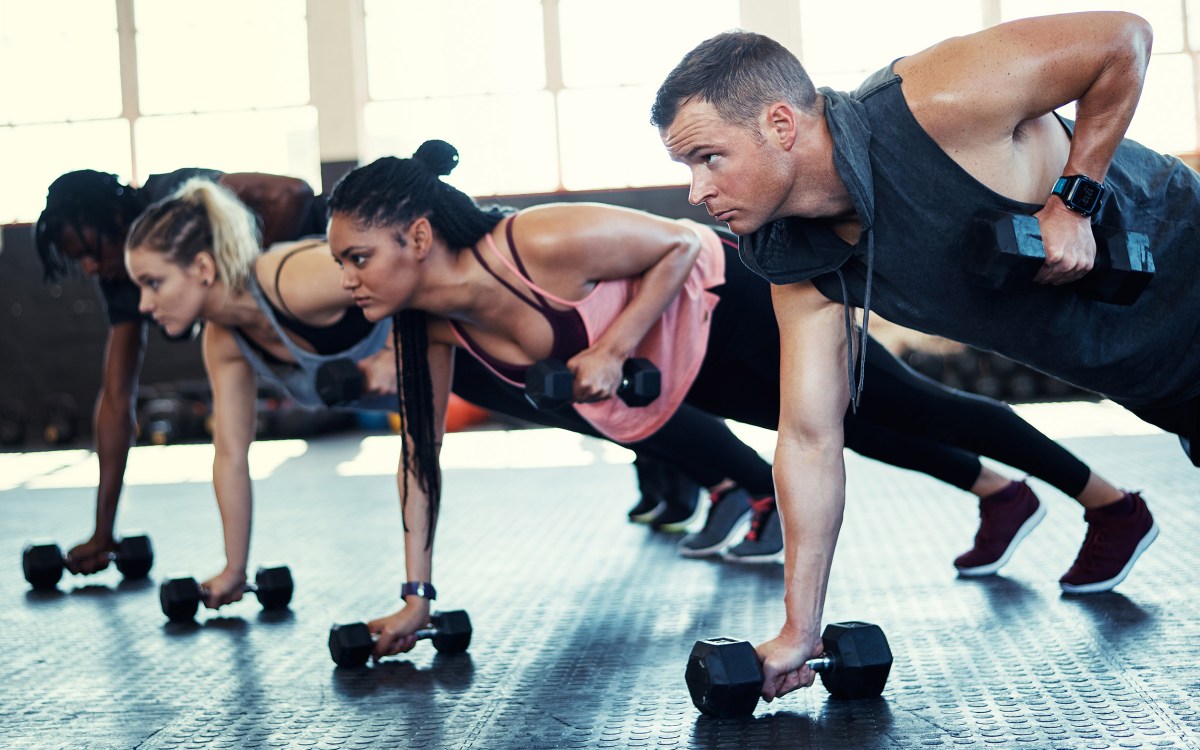 People exercising using dumbbells.