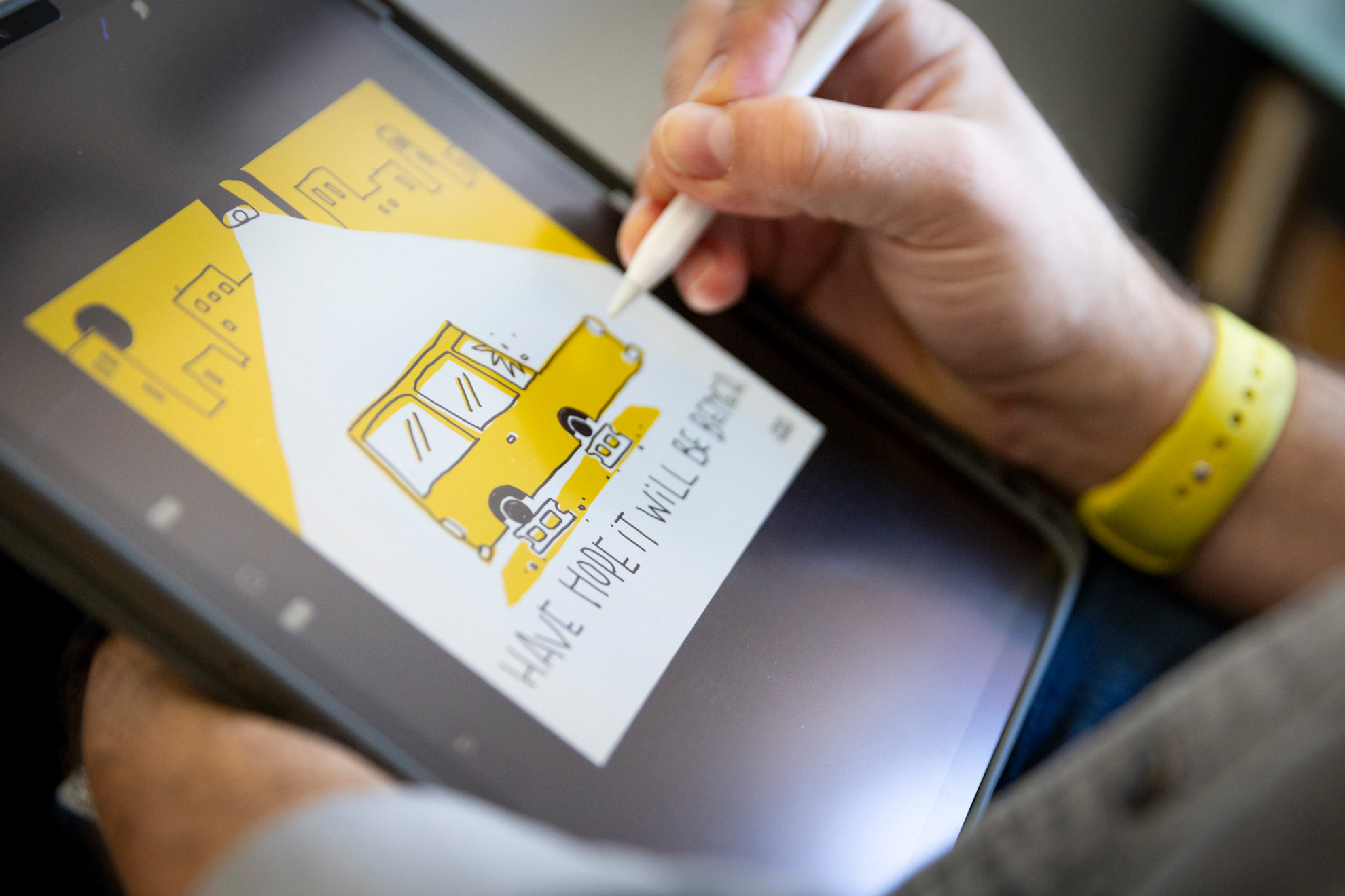 Scott Murry, Digital Illustrator and Senior Designer for the Harvard Library, draws in his home office.