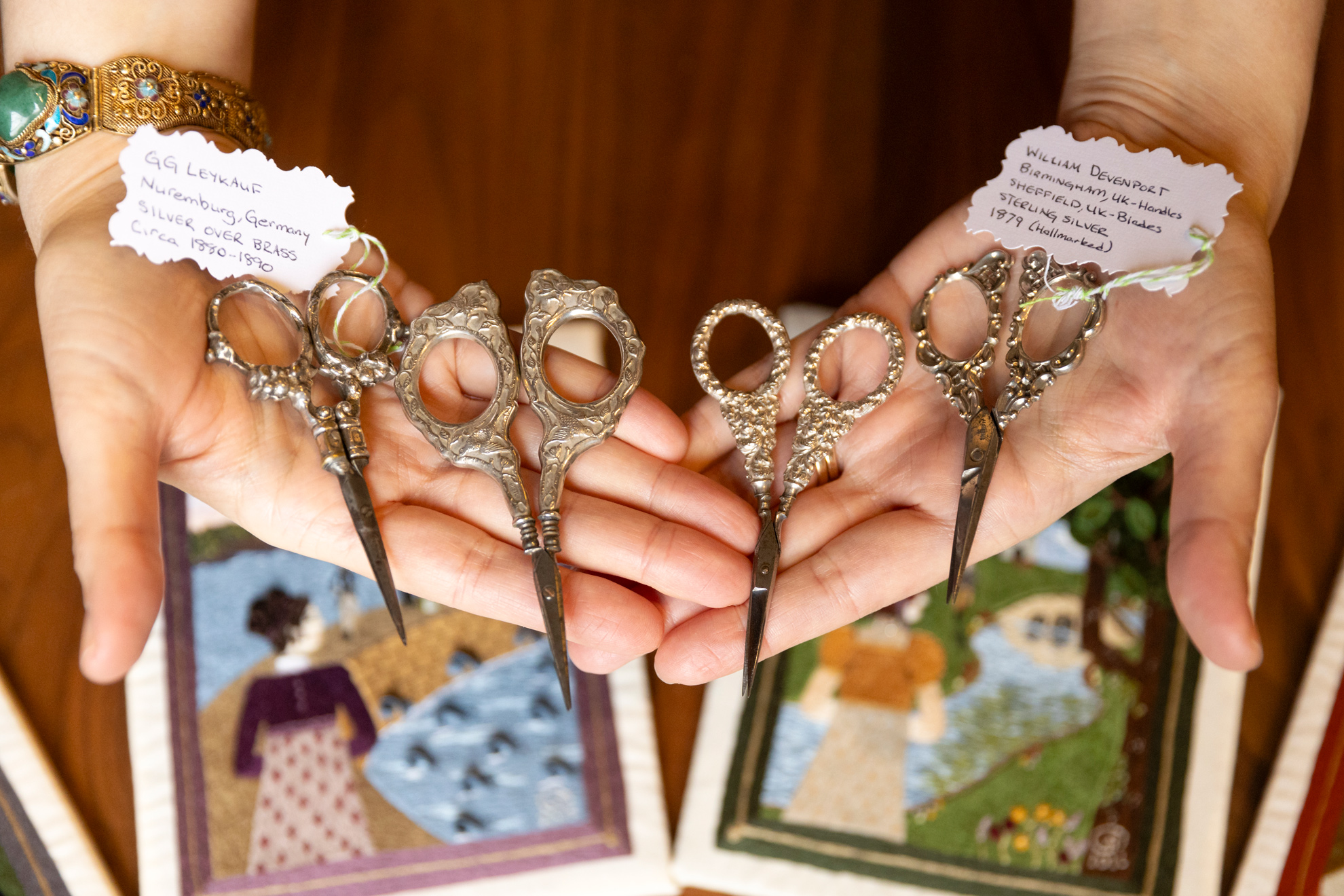 Veronica Bagnole (pictured), Digital Project Manager for the Harvard Graduate School of Design and embroiderer, showing several of the antique embroidery scissors she collects.