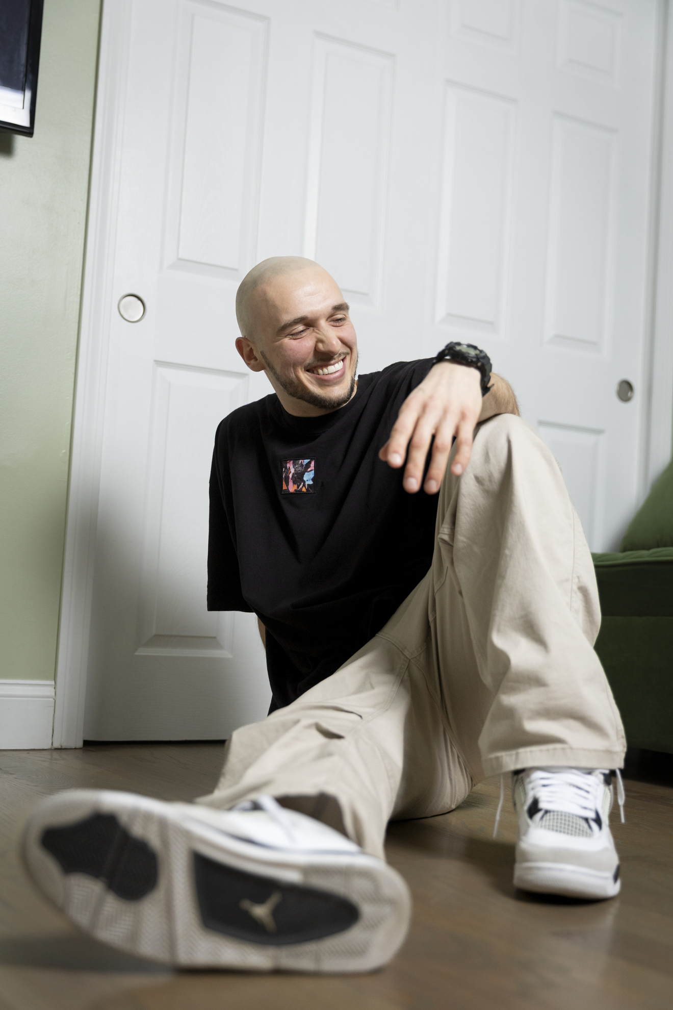 Stanislav Karachev, Energy Performance Engineer for Harvard Medical School, dancer, and poet, posing for a photo in his apartment in Roxbury.