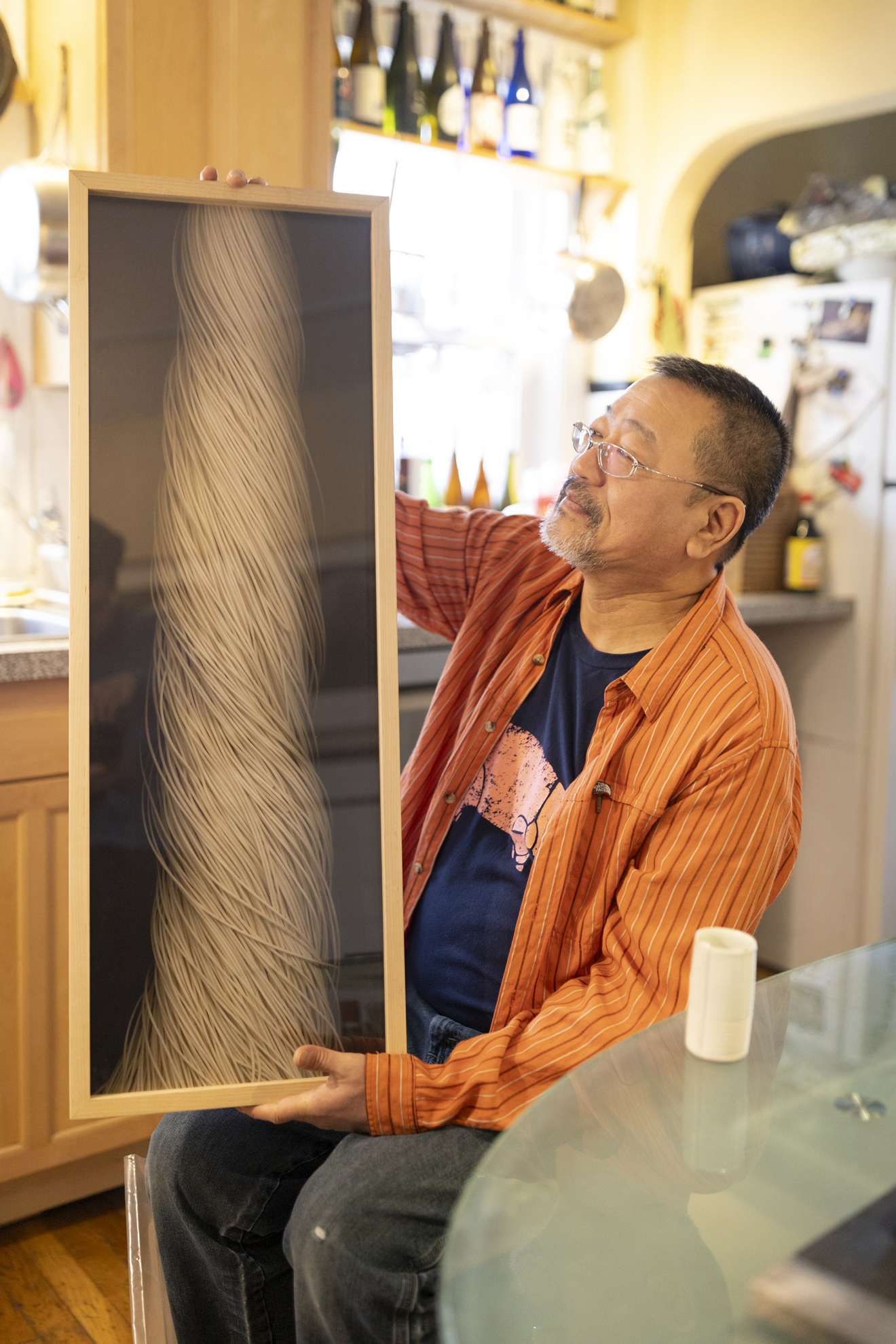 Toru Nakanishi, Exhibition Production Specialist at the Harvard Art Museums, photographer, and sculptor showing the photograph that will be in the Staff Art Show.