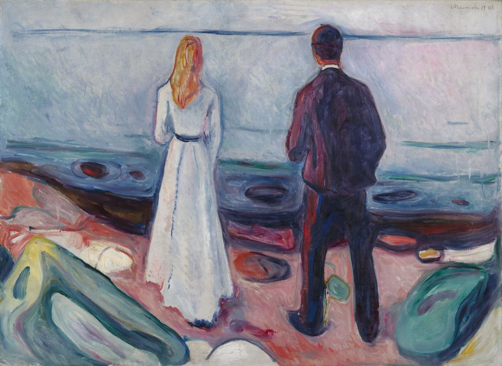 a man and a woman standing on the shore together