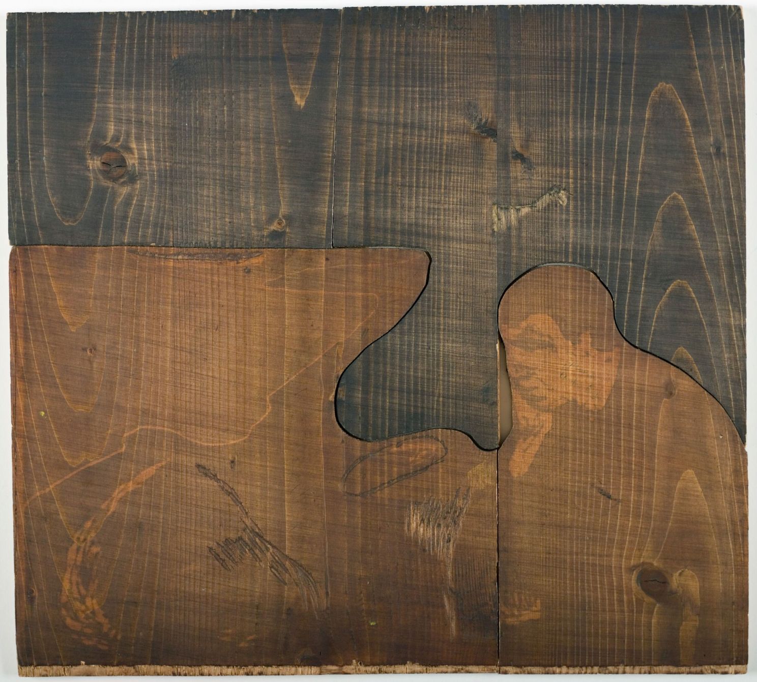 man looking sad carved into a wood block 