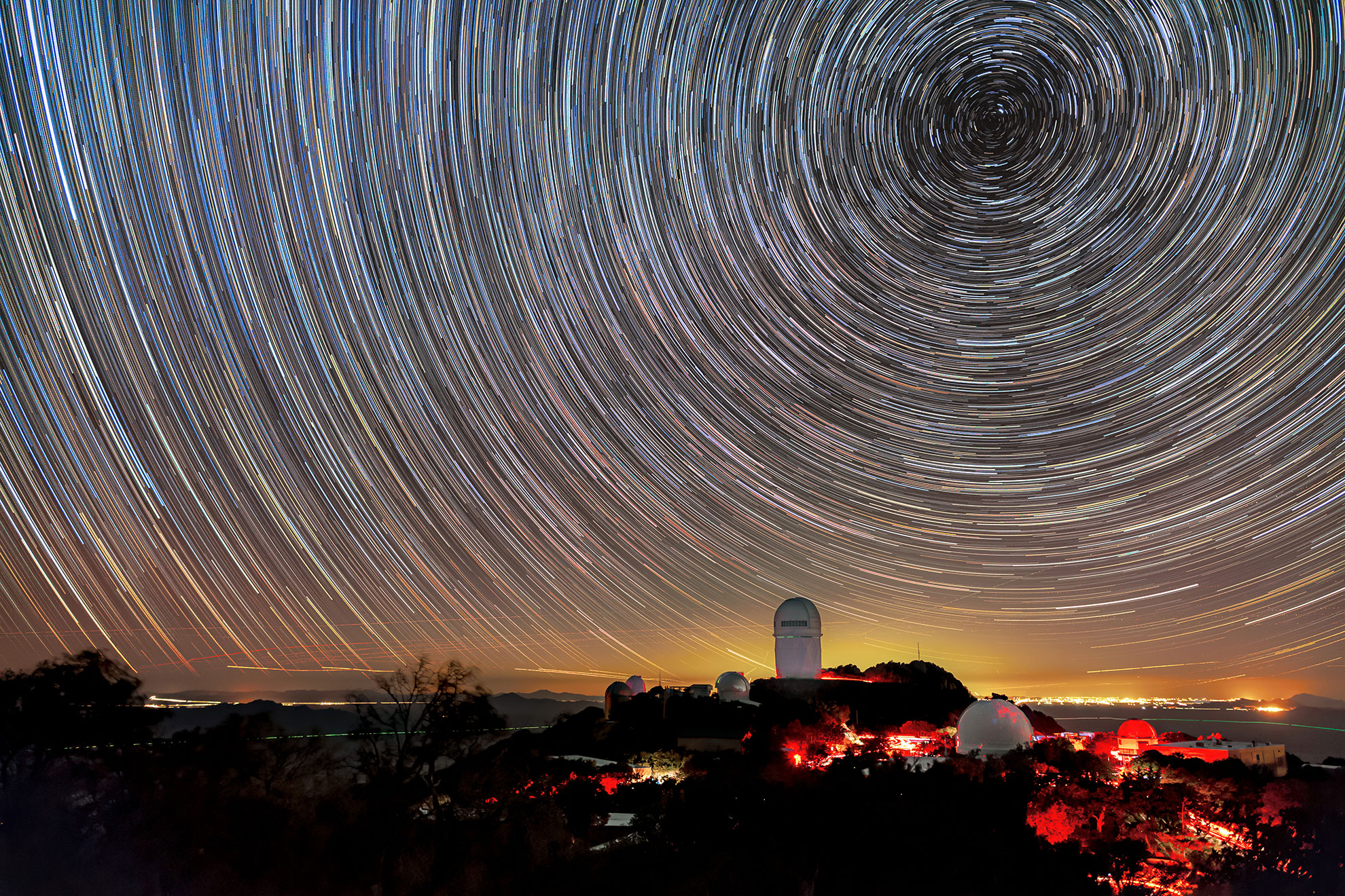 The Mayall Telescope at the Kitt Peak National Observatory in Arizona, shown here beneath star trails.