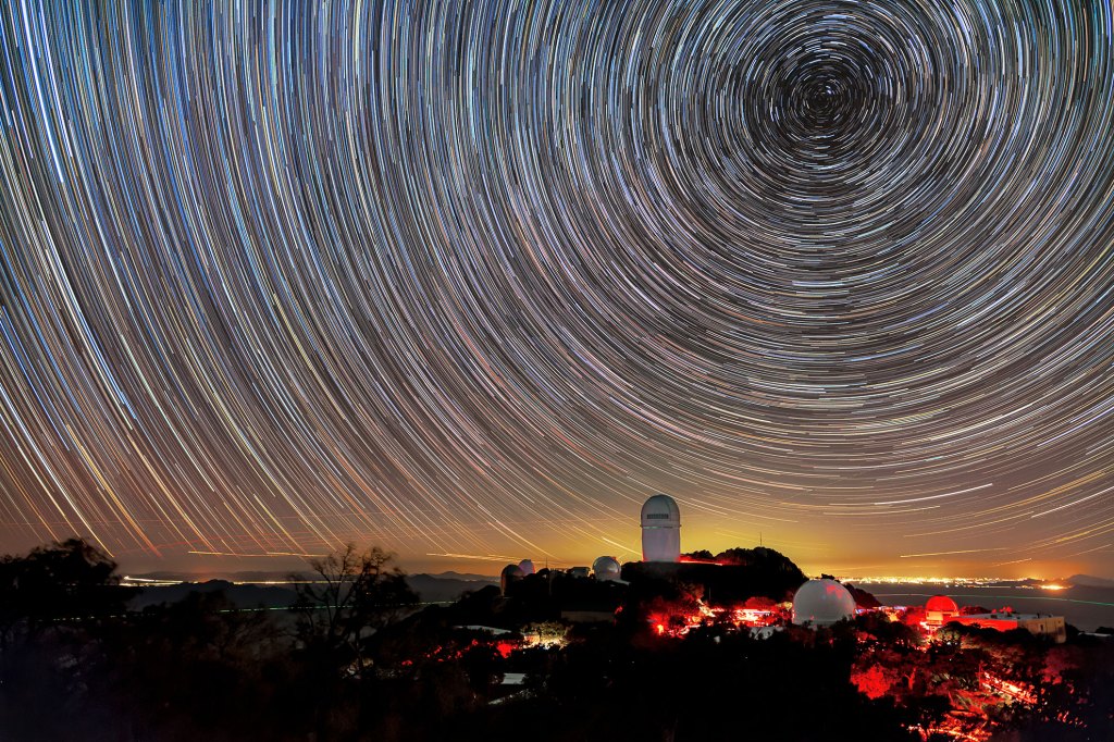 The Mayall Telescope at the Kitt Peak National Observatory in Arizona, shown here beneath star trails.
