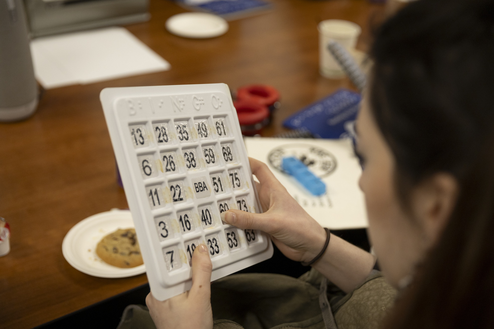 A student examines a braille bingo card.
